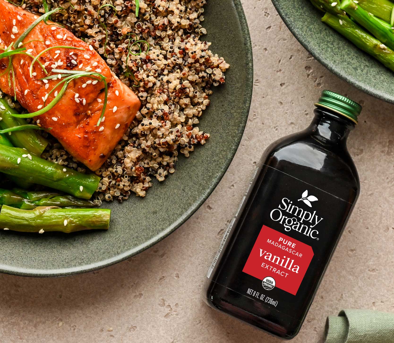 8oz featured image photo of 8oz vanilla bottle beside a dish with salmon, asparagus, and quinoa