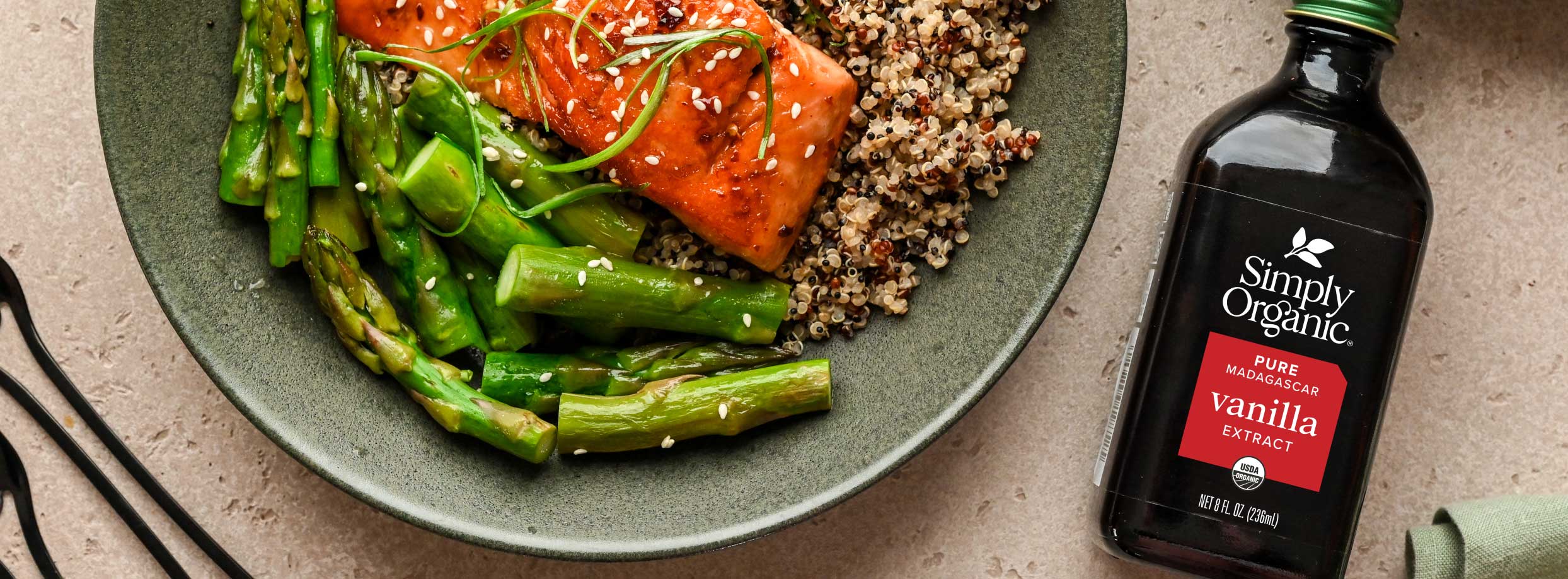 8oz featured image photo of 8oz vanilla bottle beside a dish with salmon, asparagus, and quinoa